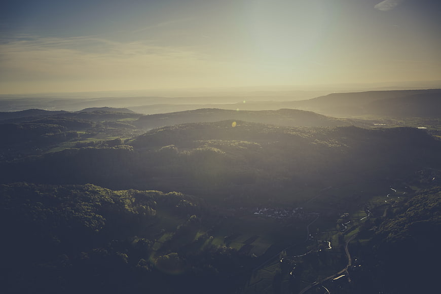 Aerial View of Misty Forested Hills at Golden Hour