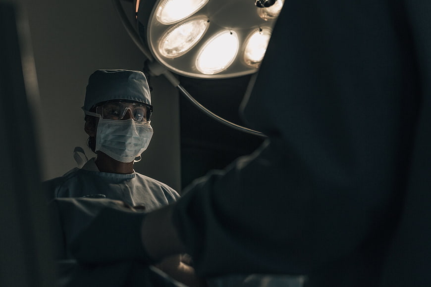 Surgeon in Operating Room Under Surgical Light