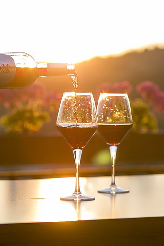 Pouring Rosé Wine at Sunset