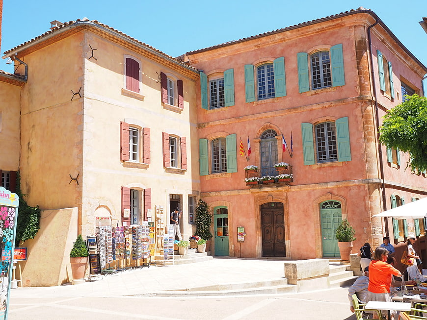 Colorful European town square with pink and yellow buildings