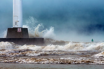 Stormy Ocean Waves Crashing Against Lighthouse Pier