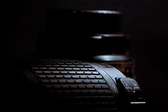 Close-up of vintage camera lens in dark moody lighting