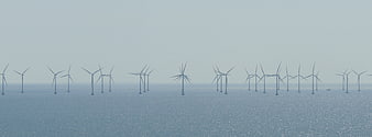 Offshore Wind Farm in Hazy Muted Blue Waters