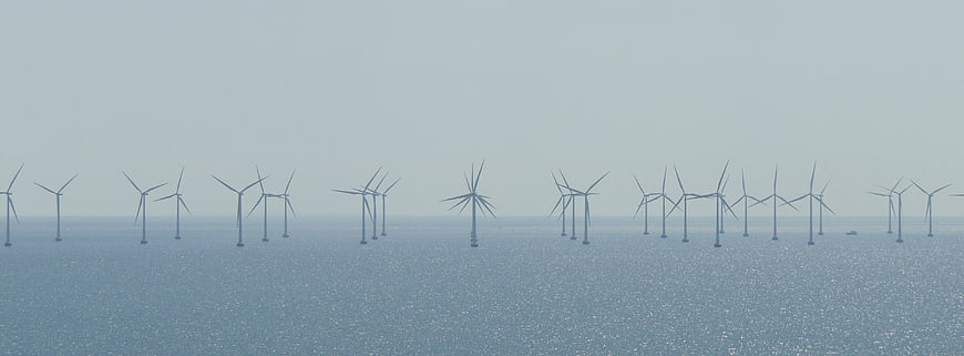 Offshore Wind Farm in Hazy Muted Blue Waters