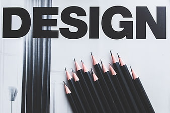 Black pencils arranged below bold Design typography
