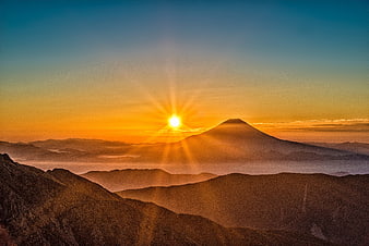 Sunrise Over Mount Fuji with Sunburst and Mountain Layers