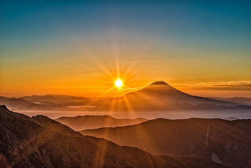 Sunrise Over Mount Fuji with Sunburst and Mountain Layers