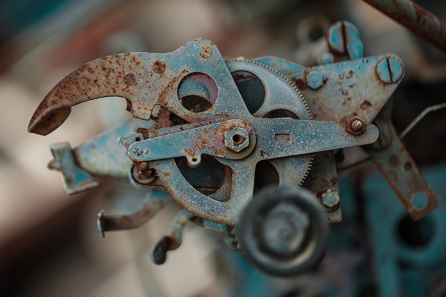 Close-up of rusty blue industrial gears and metal mechanism