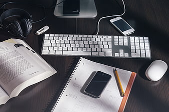 Modern Workspace with Keyboard, Smartphone, and Notebook
