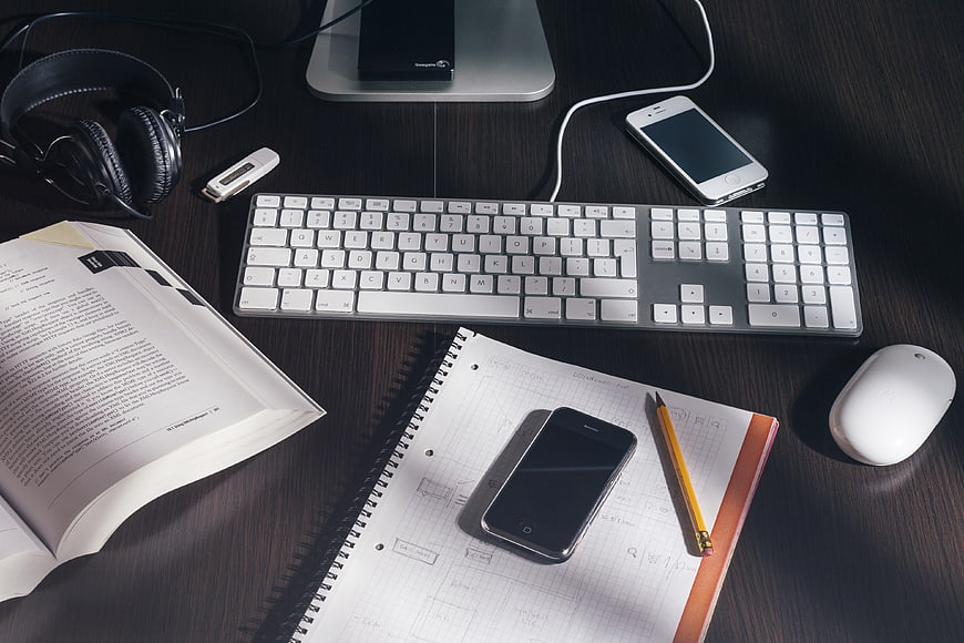 Modern Workspace with Keyboard, Smartphone, and Notebook