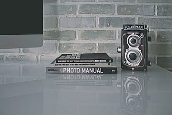 Vintage Rolleiflex Camera and Photography Books on Desk