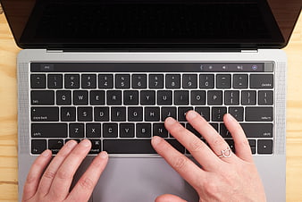 Top View of Hands Typing on Laptop Keyboard