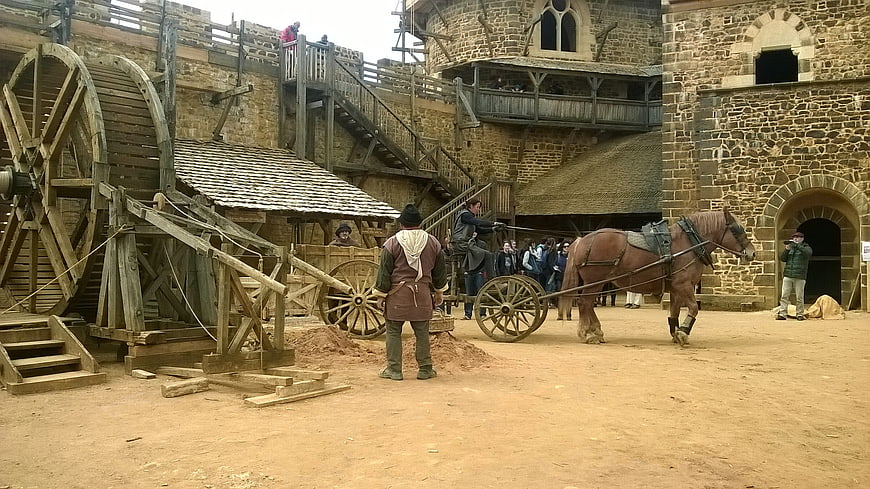 Medieval Castle Courtyard with Horse-Drawn Cart and Water Wheel