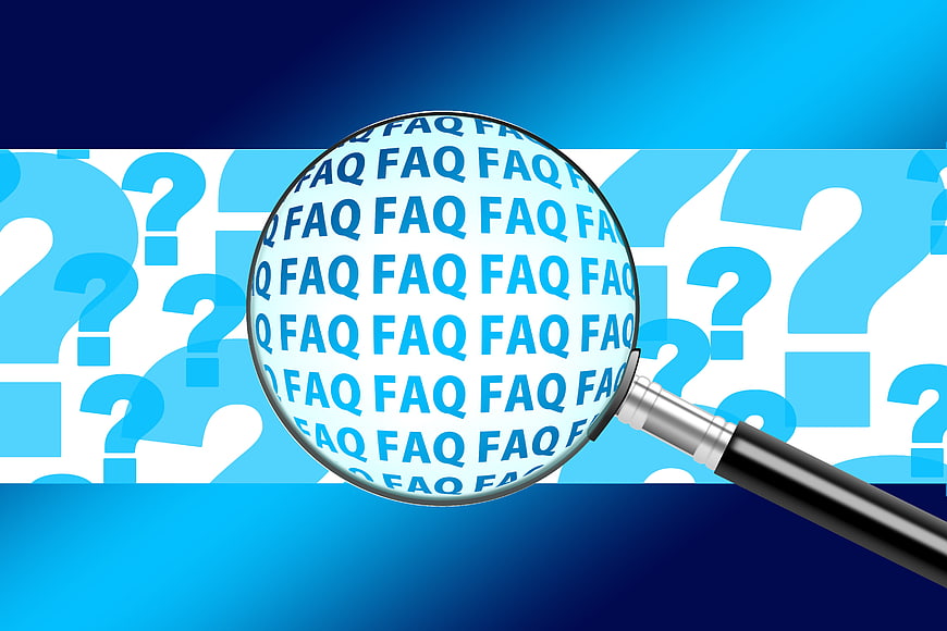 Magnifying glass over FAQ text and question marks background
