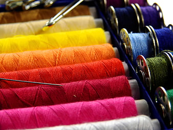 Colorful Spools of Sewing Thread in a Box