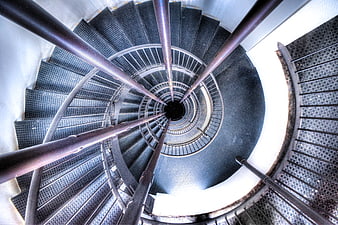Top-down view of industrial spiral staircase with metal steps