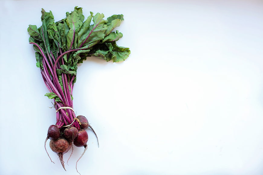 Fresh Beets with Greens on White Background