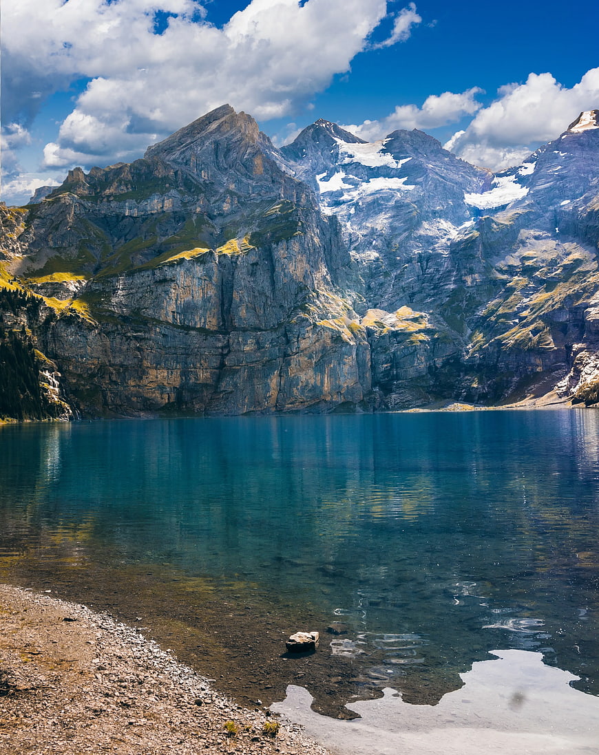 Alpine Lake with Snow-Capped Mountains and Blue Sky