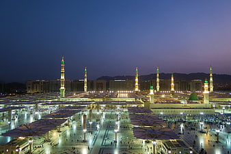 Masjid al-Nabawi at Night with Illuminated Minarets and Prayer Grounds
