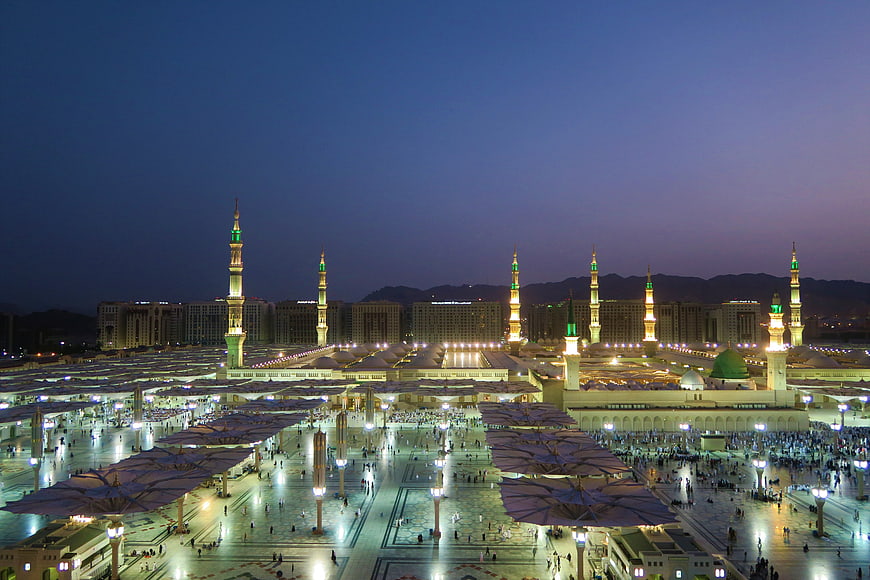 Masjid al-Nabawi at Night with Illuminated Minarets and Prayer Grounds