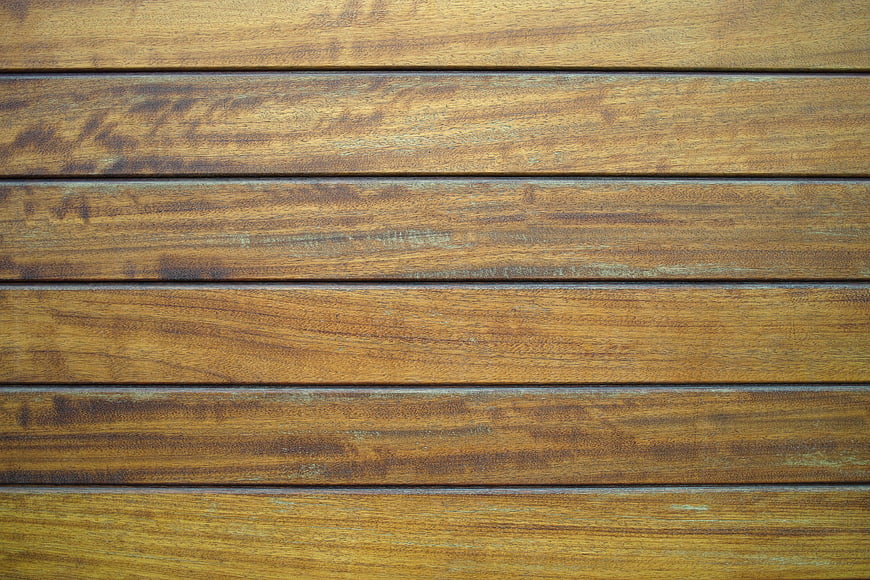 Close-up texture of weathered brown wooden deck planks