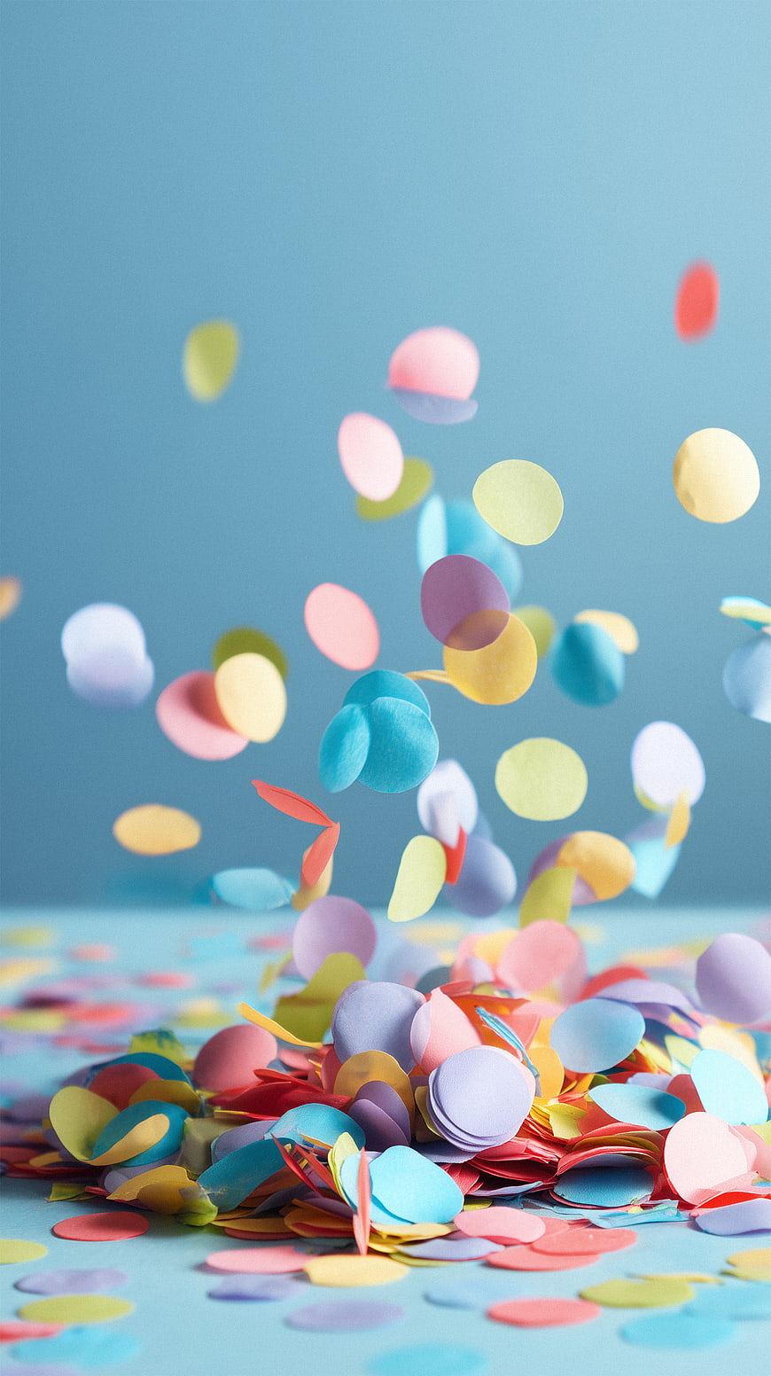 Colorful Confetti Falling on Blue Background