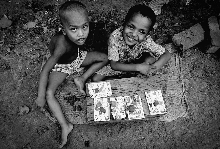High angle black and white photo of two young boys with books