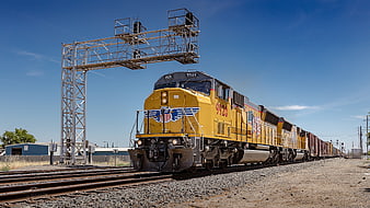Yellow Union Pacific Freight Train Passing Railroad Signal Tower