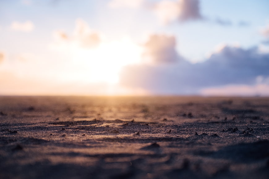 Blurred Sunset Horizon Over Sandy Beach Shore