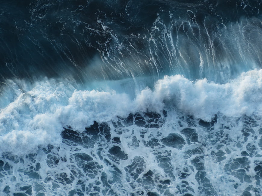 Aerial View of Powerful Blue Ocean Waves Crashing