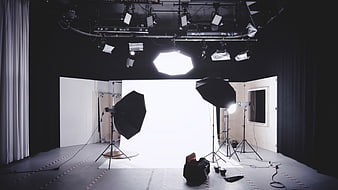Professional photography studio setup with lighting equipment and white backdrop