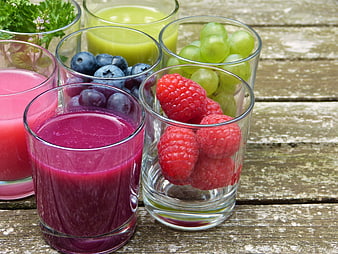 Fresh Fruit Smoothies and Berries in Glass Jars on Rustic Wooden Table