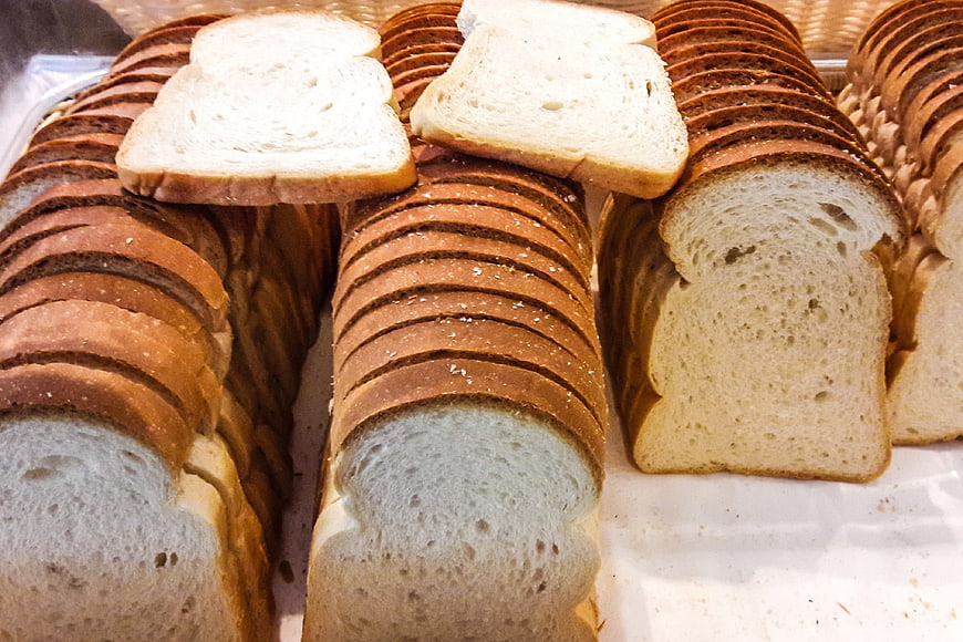 Freshly Sliced White Bread Loaves in Bakery Display