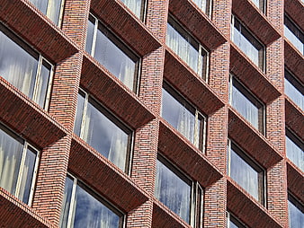 Red Brick Building Facade with Geometric Window Pattern