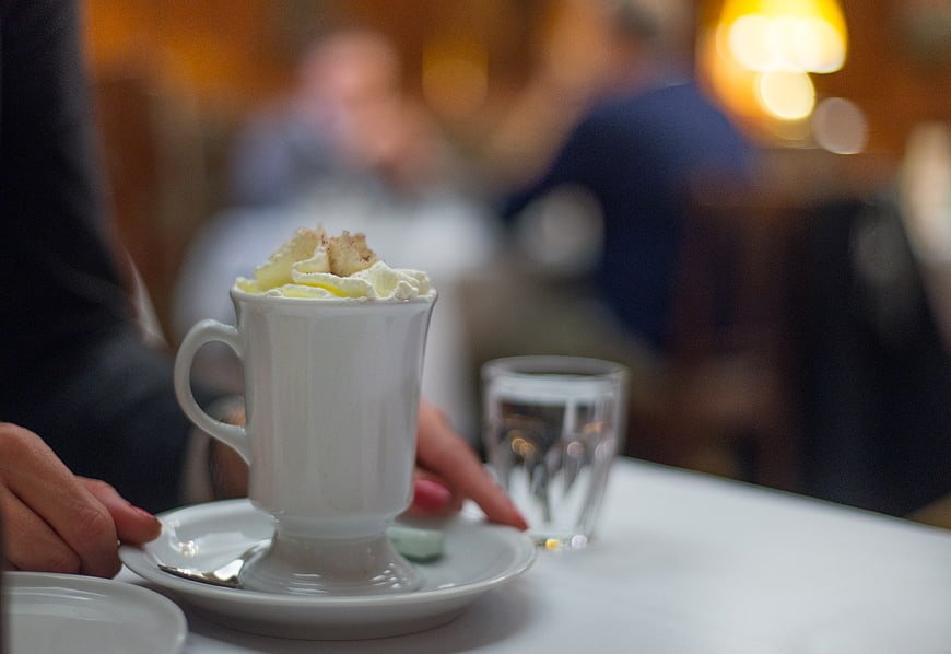 Hot chocolate with whipped cream in a cozy cafe setting