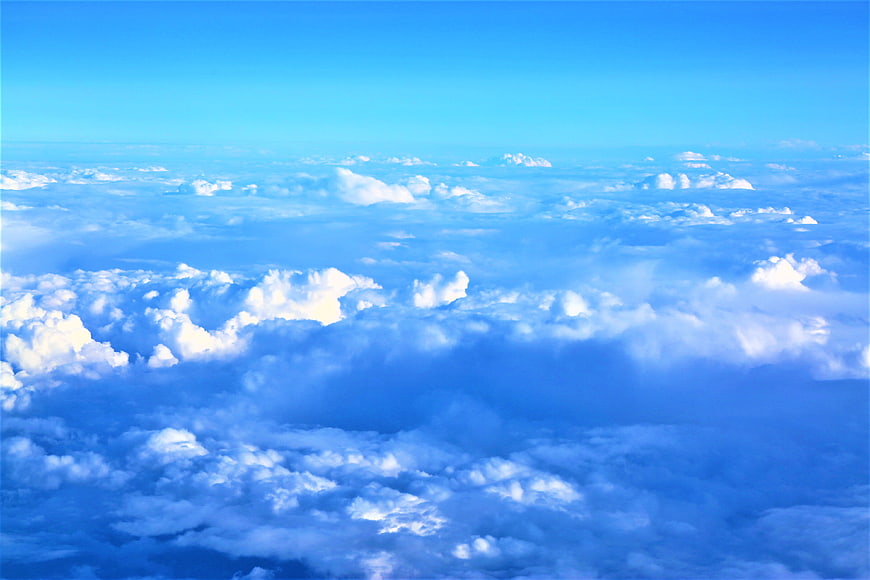 Aerial View of Fluffy White Clouds Against Blue Sky
