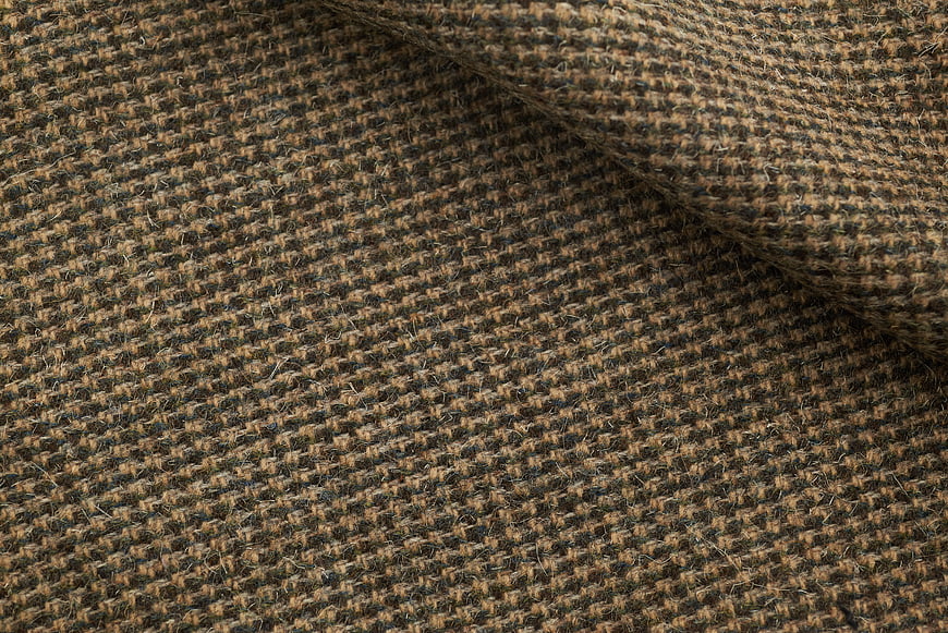 Close-up of brown and black tweed fabric texture