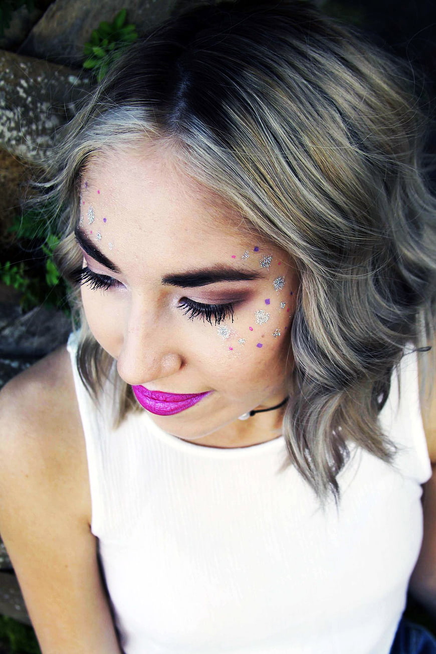 Woman with glitter makeup and bright pink lipstick