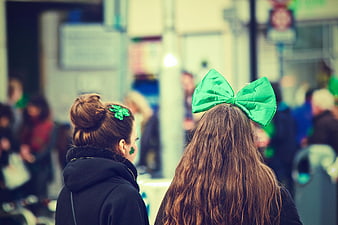 Two Women Wearing Green Bow and Shamrock for St. Patrick's Day