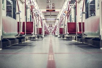 Empty subway car interior with red seats and perspective view