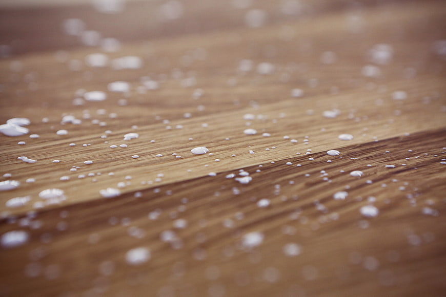 Milk Drops Scattered on Wooden Surface
