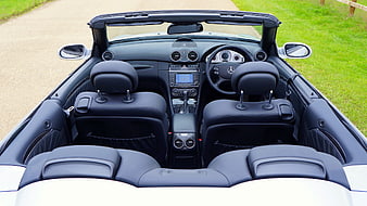 Interior of a white Mercedes-Benz SLK convertible with black leather seats