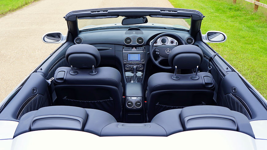 Interior of a white Mercedes-Benz SLK convertible with black leather seats