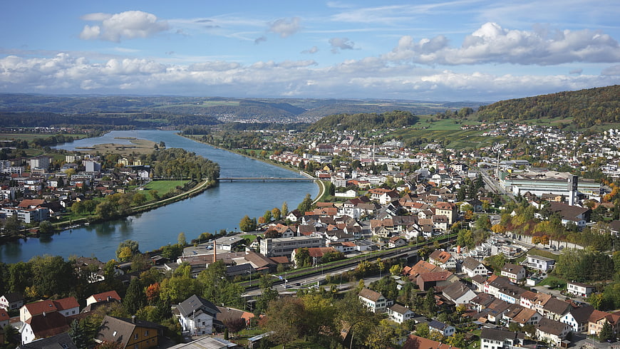Panoramic View of European Town by River in Autumn