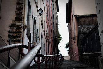 Narrow European Alley with Stairs and Rusty Railing