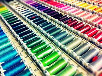 Colorful Spools of Thread Arranged in Rows for Sewing and Embroidery
