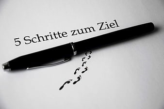 Black Pen on Paper with German Text and Footprints