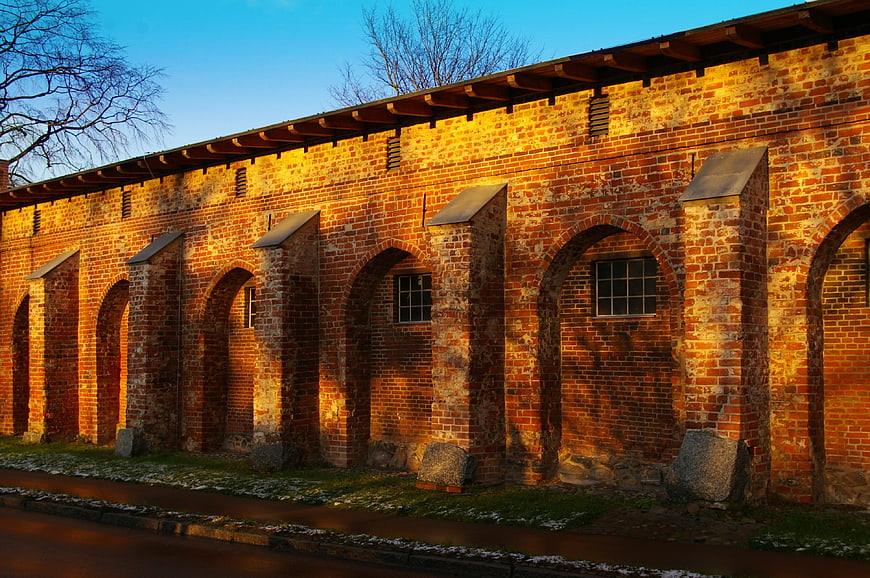 Golden hour sunlight on historic red brick monastery wall