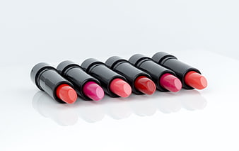 Row of colorful lipsticks on white background