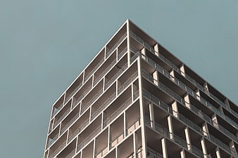 Modern White Apartment Building Against Blue Sky